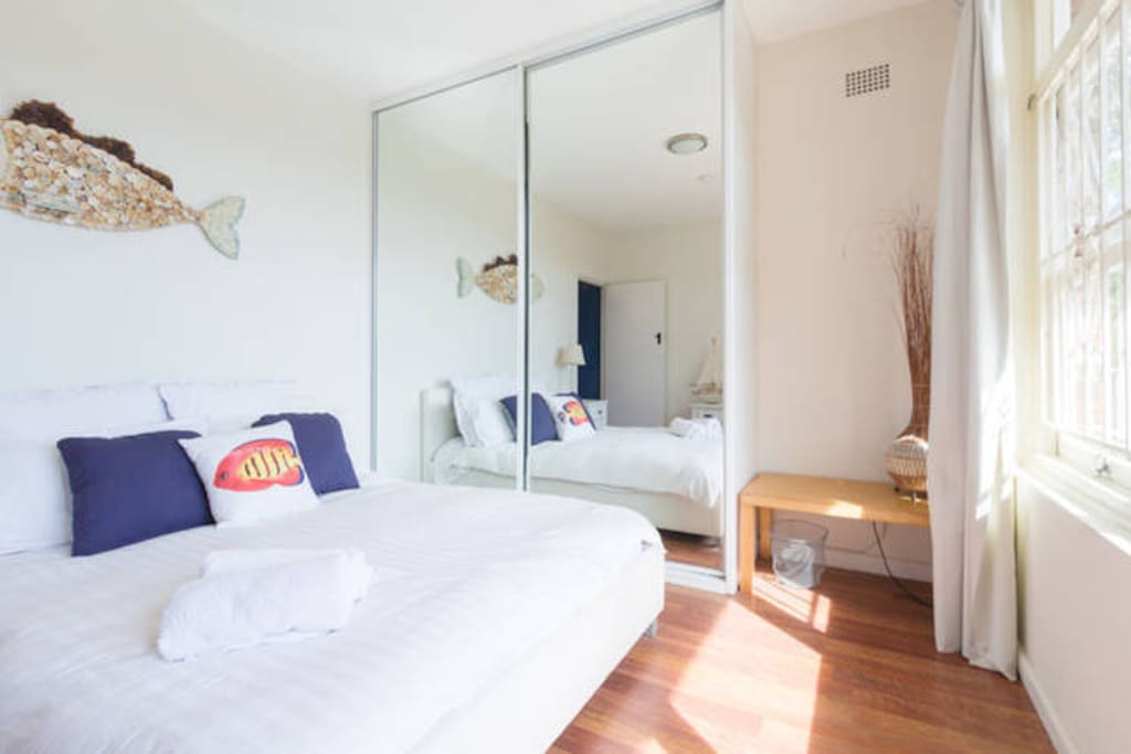 Light, bright bedroom with sunrise views