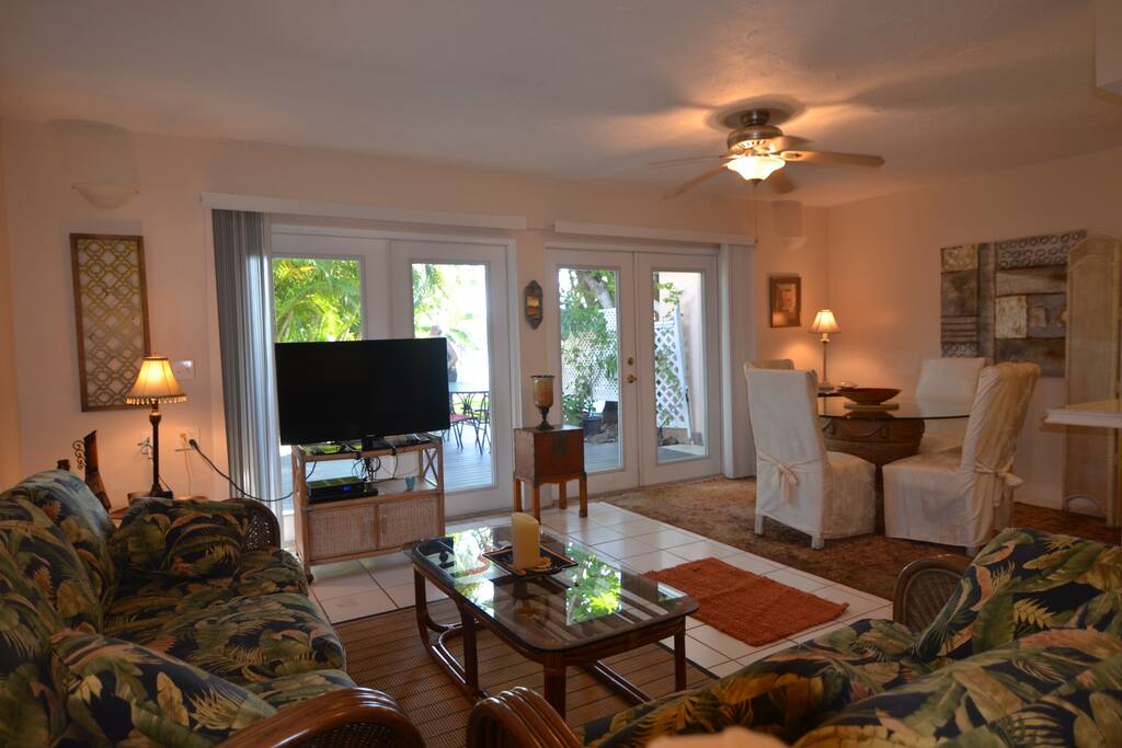 French Doors lead to Patio from Living Area and Dining Table for six People Attached Living area to Dining