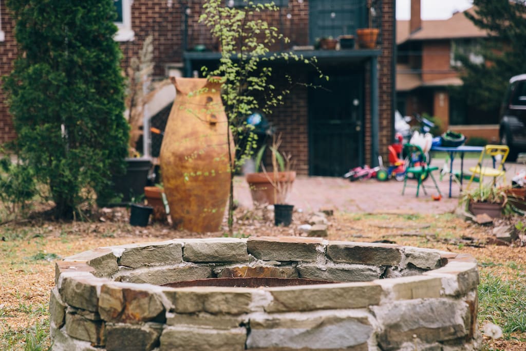 Overlooking fire pit towards daylight basement apartment entrance
