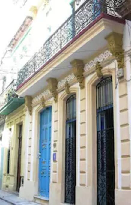 The light blue door at number 60 is the entrance.
