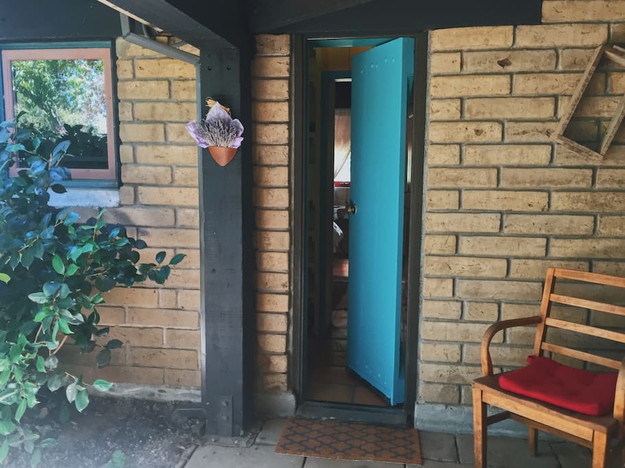 Private entrance through turquoise door to your guest suite.