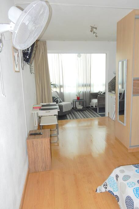 Specious studio with wall fan opposite bad area.