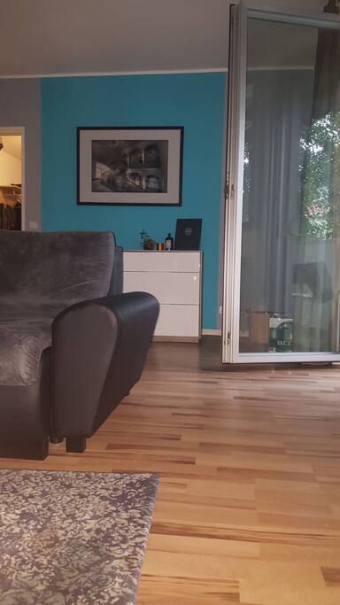 The sofa can also be turned into a second bed. On the right side you see the door to the balcony