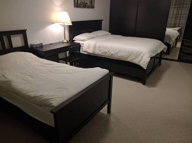 A private bedroom with two beds by Yonge subway