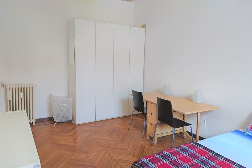 Private bedroom view 2. One of the two big, white closets will be at your disposal. If needed, a third chair can be as well available for you.