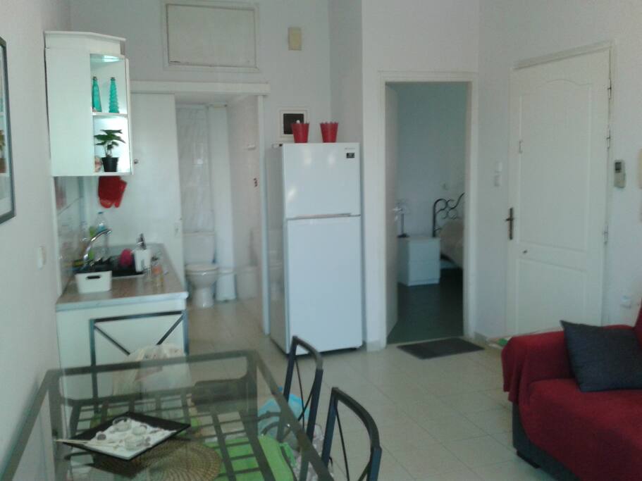 Another view of the living room and the kitchen. The sofa converts to a double bed.
