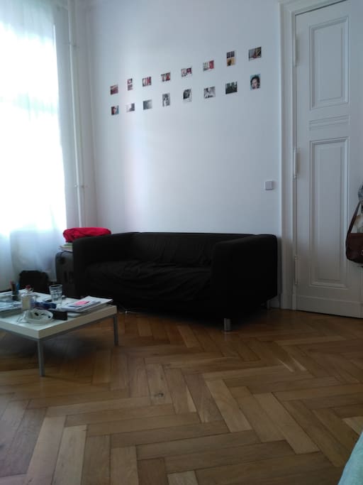 The couch where you'll enjoy the room's and street's atmosphere