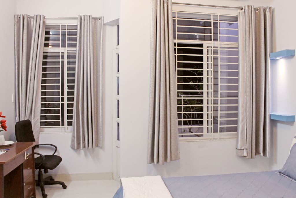 Large windows to catch sunlight and a small balcony