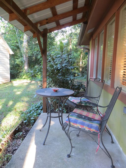 Front porch with metal table and chairs.