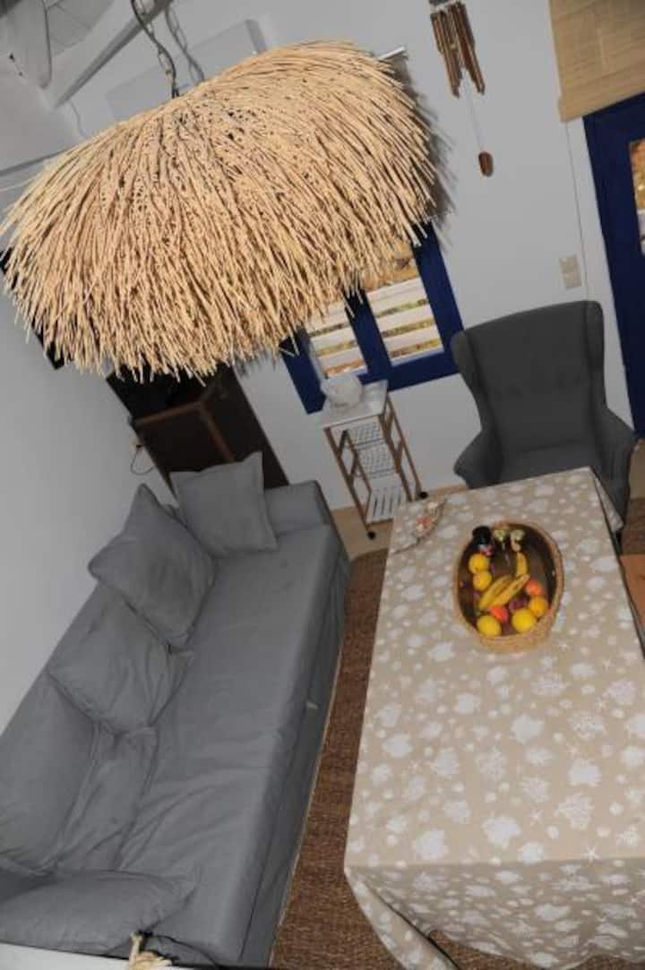 The living area with the interesting ceiling light fixture. 