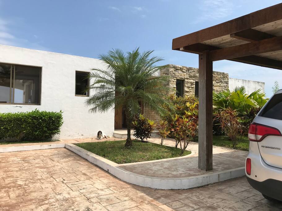Entrance. We have a covered parking lot for two cars and an uncovered area for two or three additional cars.