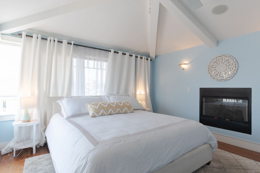 MASTER BEDROOM WITH FIREPLACE AND PRIVATE BALCONY WITH SEATING AREA