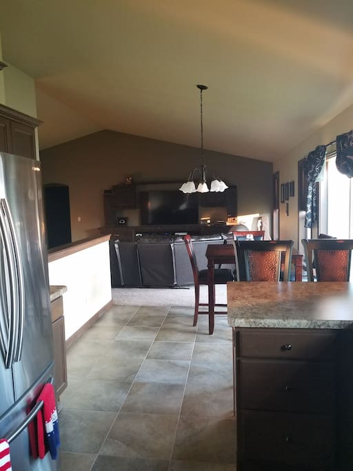 open concept kitchen, dining, living room. Large built in entertainment center with 70" centerpiece!!!