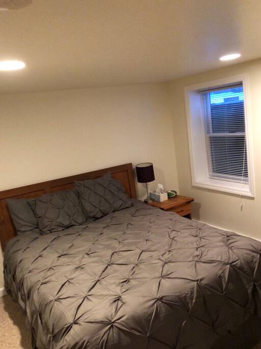 Comfy queen bed, with side table and reading lamp.