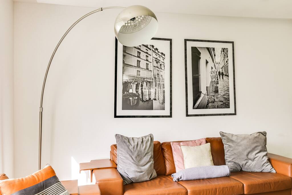Soft cushions and a reading lamp that make the space feel cosy and warm