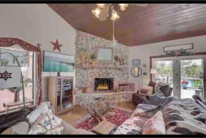 Living room with comfy couch for the whole family to watch a movie on the big screen TV after a big day on the water!