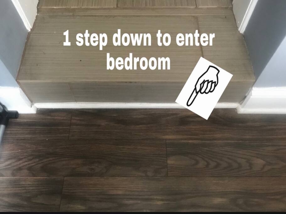 Go through kitchen - one step down to enter bedroom.
