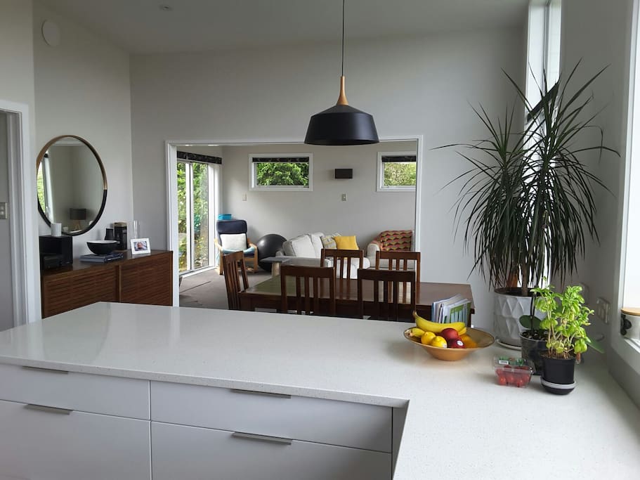 Flow from kitchen through to lounge, with stacker doors out to new deck and patio area