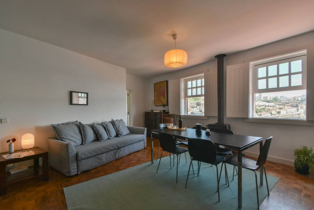 spacious living room with table for six people and a comfortable sofa