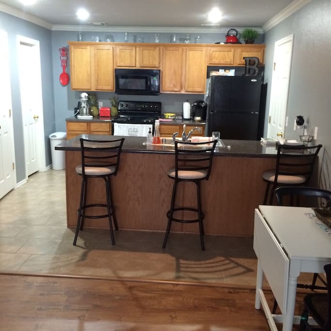 Kitchen fully stocked with appliances and dishes. Kitchen also has snacks and drinks available for guests.
