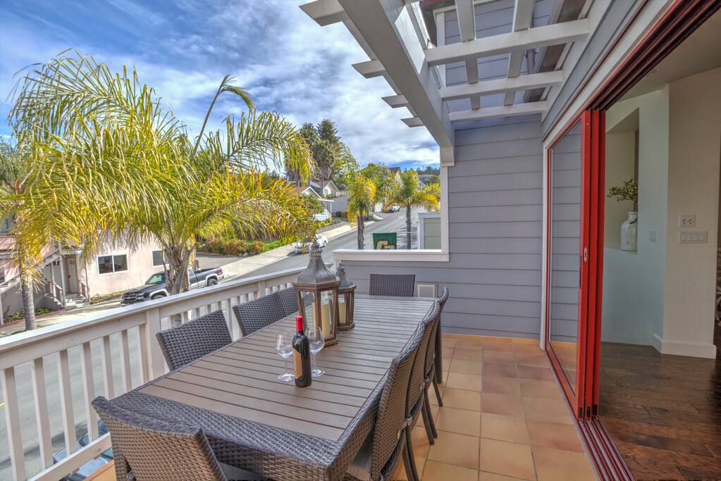 Two outdoor dining areas at SUN KISSED. The kitchen opens to the front balcony. A second dining for 6 guests is on the rooftop with BBQ center.