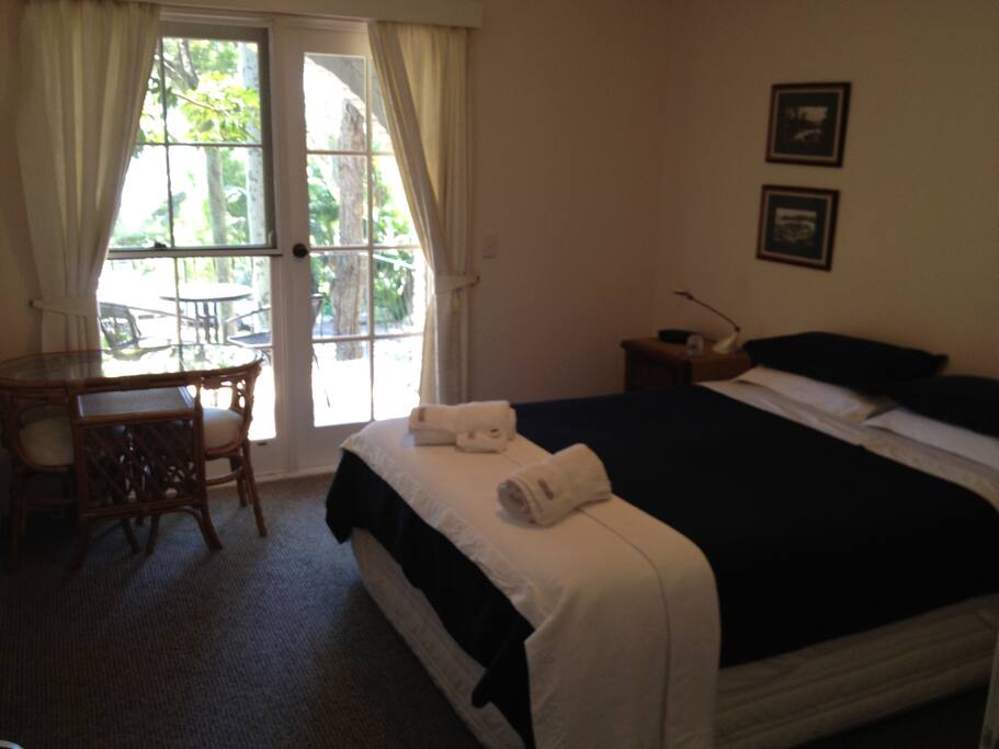 Queen bed, ensuite and balcony with Pacific Ocean views
