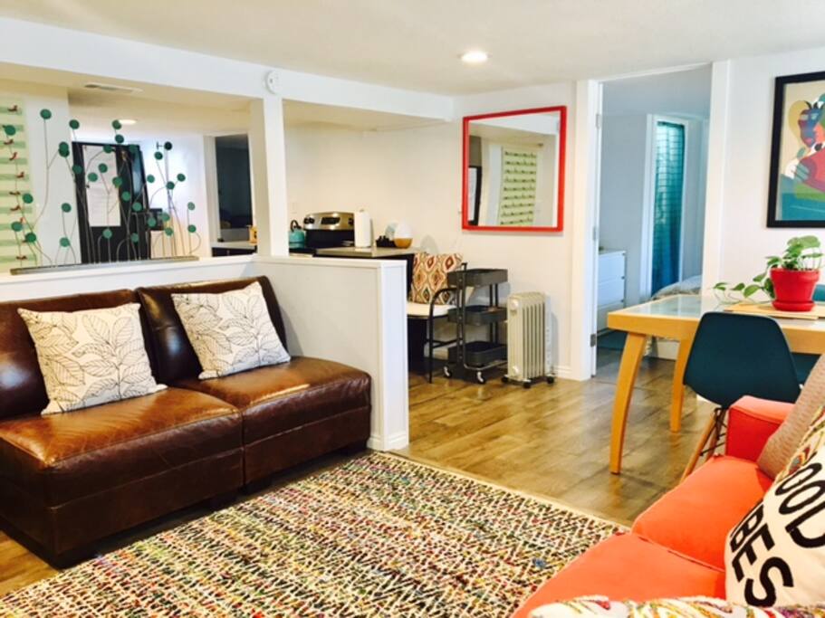 View from living to dining, main bedroom and kitchen. "GET READY" space under orange mirror.