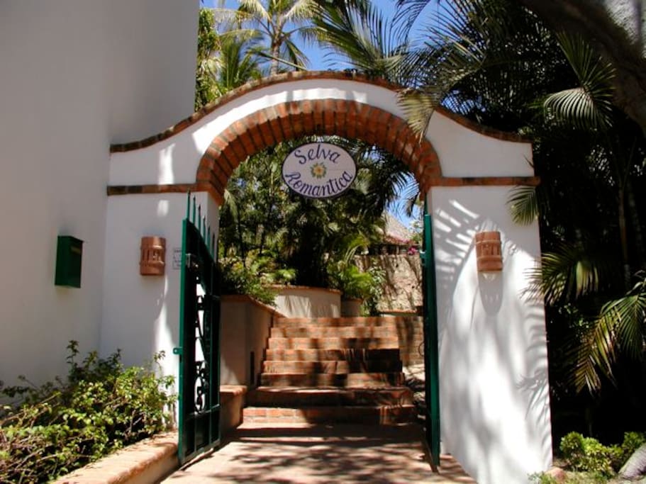 Casa Loma is located in gated Selva Romantica with lush landscaping.