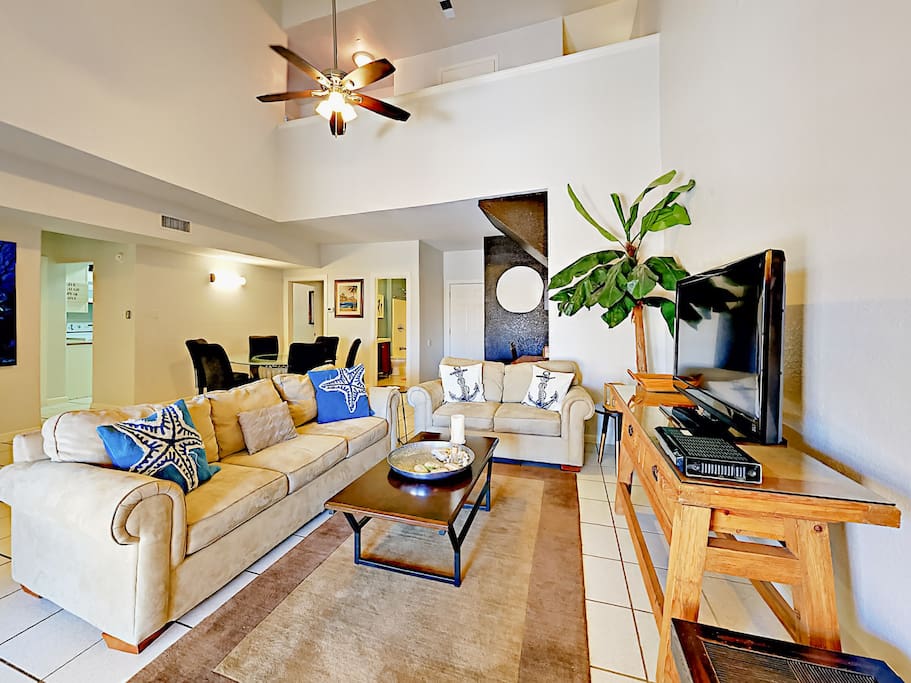 A spacious sleeper sofa and love seat face a 40” flat screen TV in the living room.