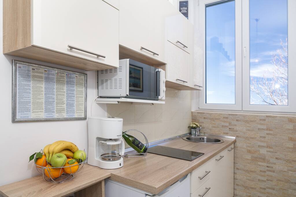 Modern kitchen equiped with all necessary appliances.