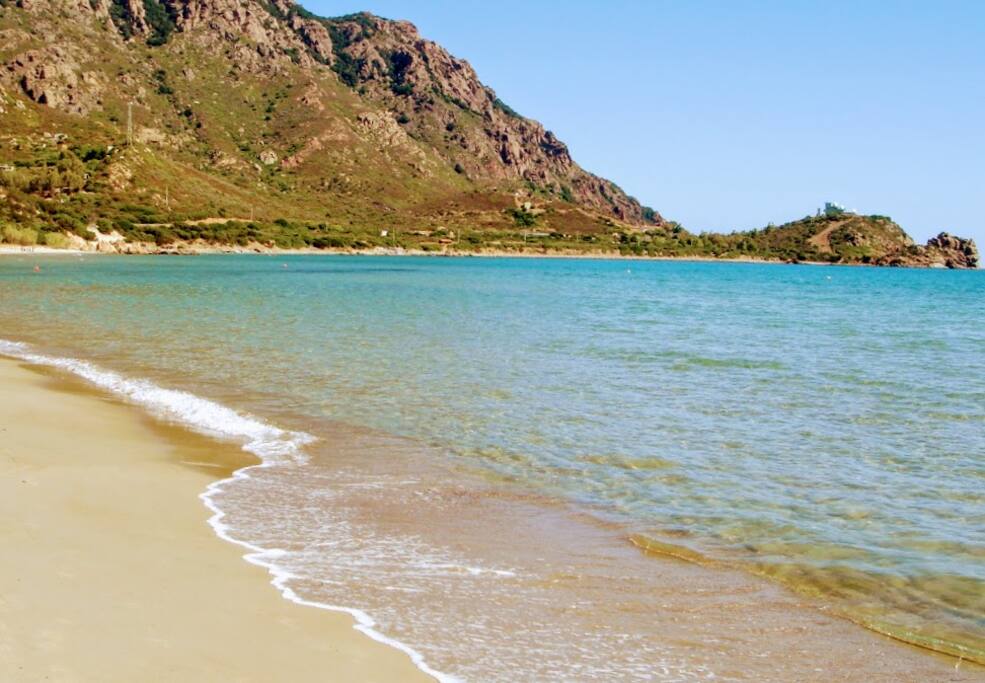 acqua limpida e bassa marea con sfondo il monte Ferru e punta is ebbas
