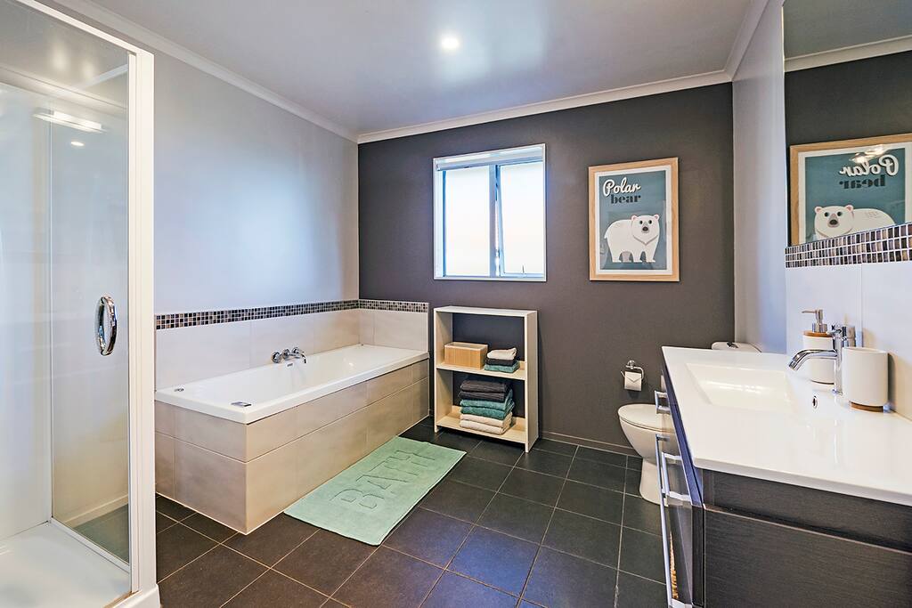 Bathroom 1 with spa bath, shower, vanity & toilet