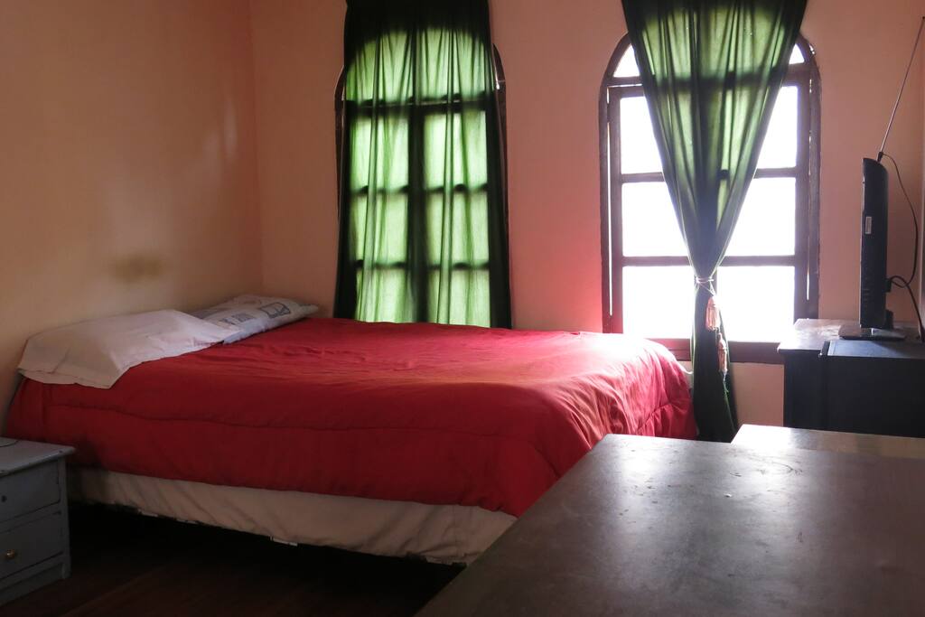 Large bedroom with double bed and sofa bed furnished with desk, plasma TV, stereo, computer (optional). Sun by the morning
