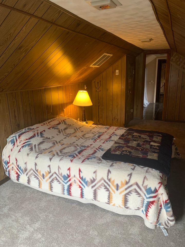 South Upstairs bedroom with queen bed, private bathroom and private deck. 