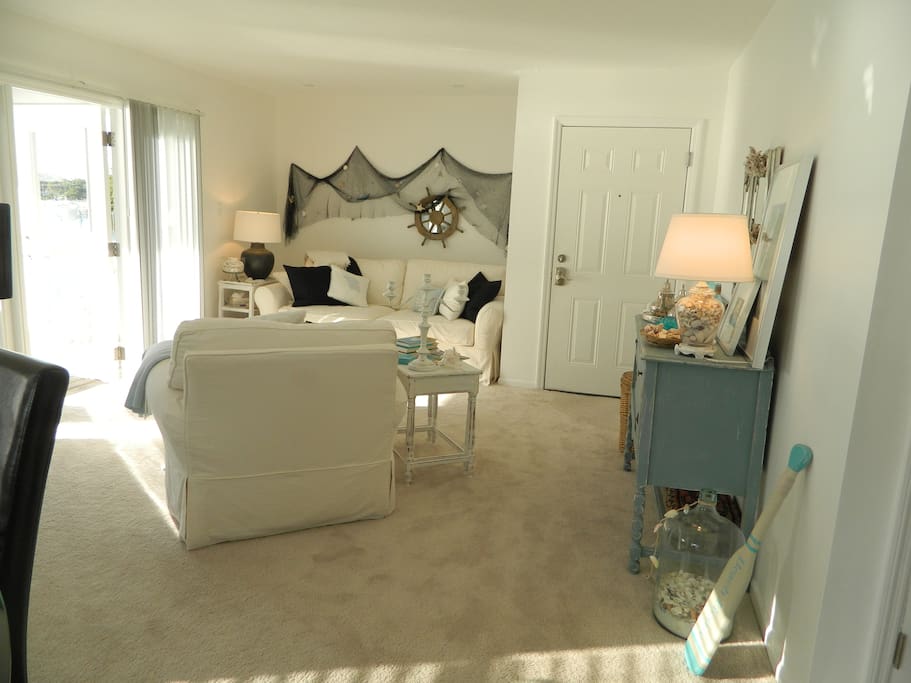 The living room overlooks the water and access the large balcony.