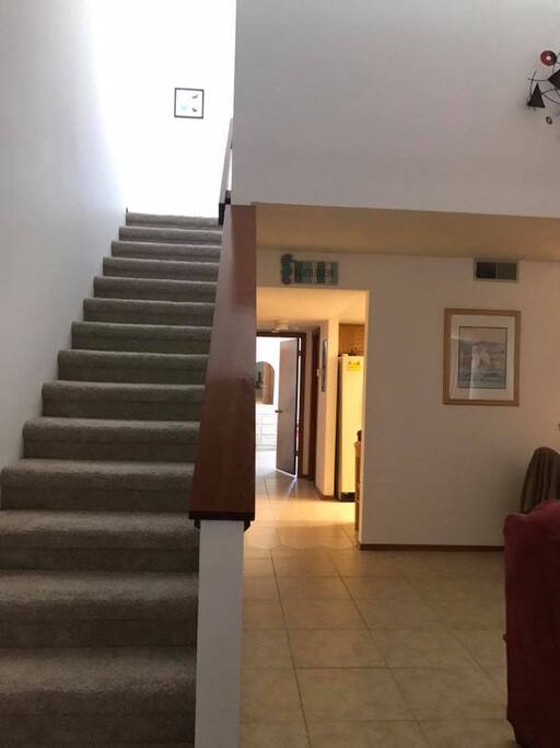 The master bedroom is upstairs. The living room/dining area, kitchen, laundry facilities, full bath and 2nd bedroom with access to the back yard and patio or on the first floor.