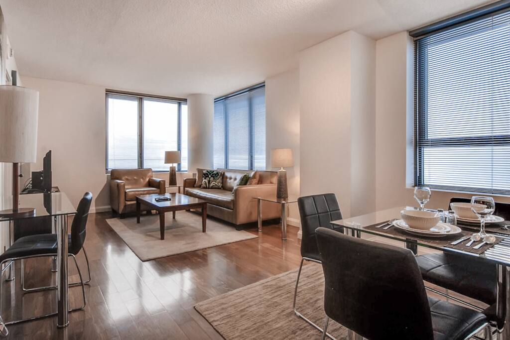 Living room with over-sized windows providing a lot of natural light and city views