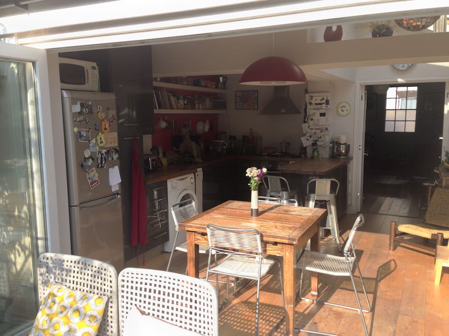 Bright extended kitchen with folding doors opening onto the garden