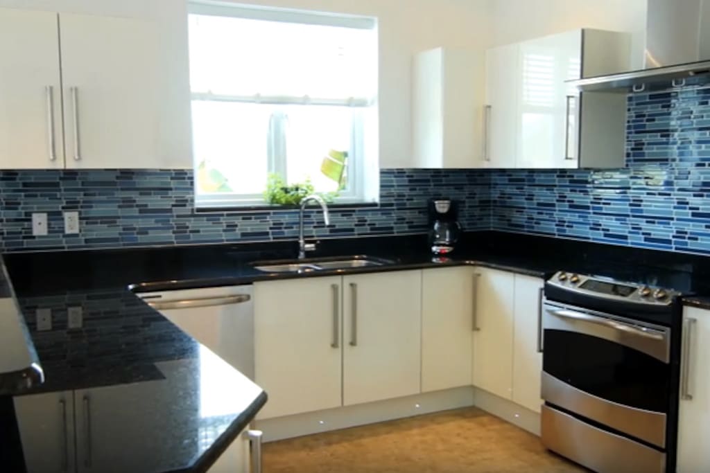Ultra-modern, sunny, inviting kitchen comes equip with coffee grinder, coffee maker, stainless steel appliances: electric glass-top range/oven, refrigerator/freezer, dual sink & dishwasher. Kitchen fully equipped with cookware/dishes/silverware/glasses & large granite counter top.