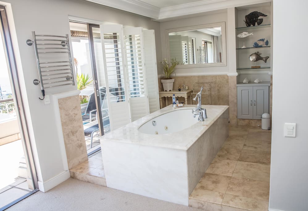 Master bathroom - open plan full bathroom with sea views, private loo