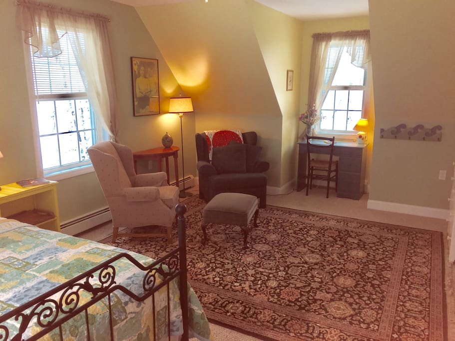 Master Bedroom. View toward reading nook with wingback chairs.