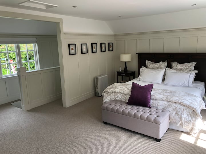 The large sunny bedroom and Super King bed with Wallace Cotton linens.