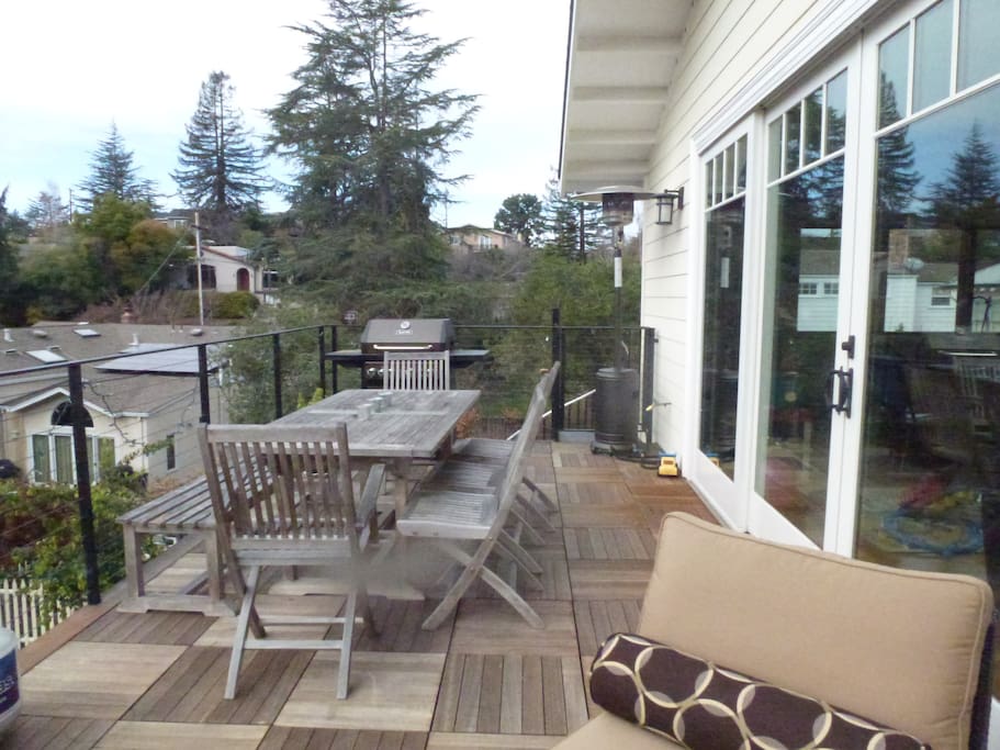 Outdoor table seating for 8-10. Gas grill and spiral staircase to backyard.