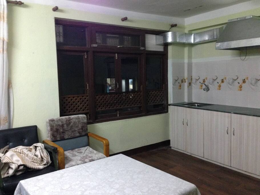 Open kitchen with Dinner table and cooking space.