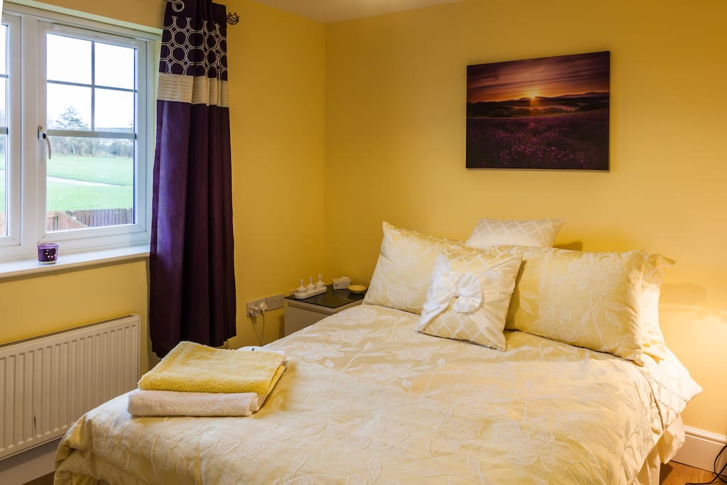 Clean double bedroom overlooking open fields