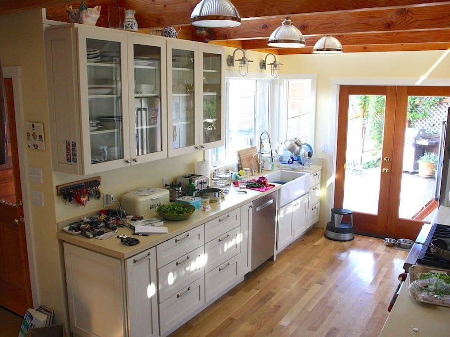 New kitchen with 6-burner Wolf range and access to patio.