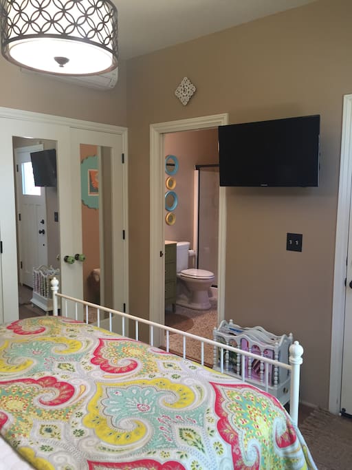 TV in the bedroom and you can see Heat/AC unit + location of bathroom.