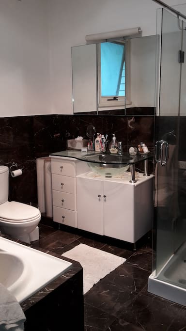 Bathroom with toilet and ajacent to a separate toilet room