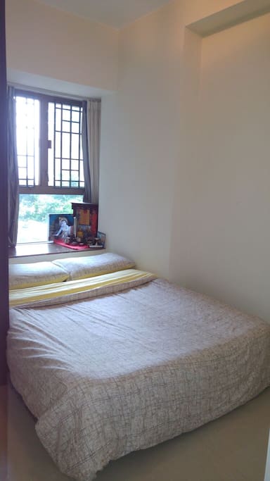 The queen sized bedroom comes with a view of the garden and pool