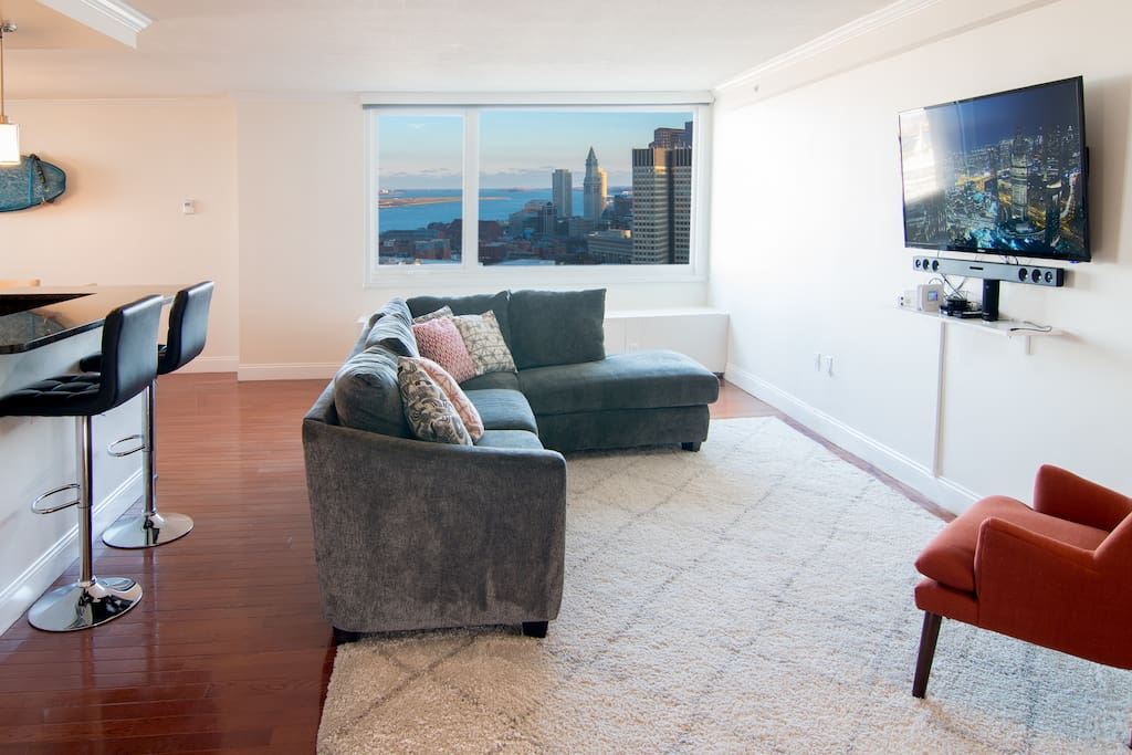 Open-plan living room with incredible view of Boston Harbor and downtown